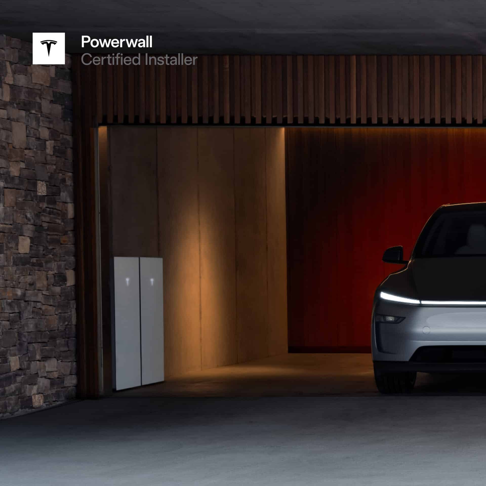 tesla car parked in garage next to two tesla powerwall batteries