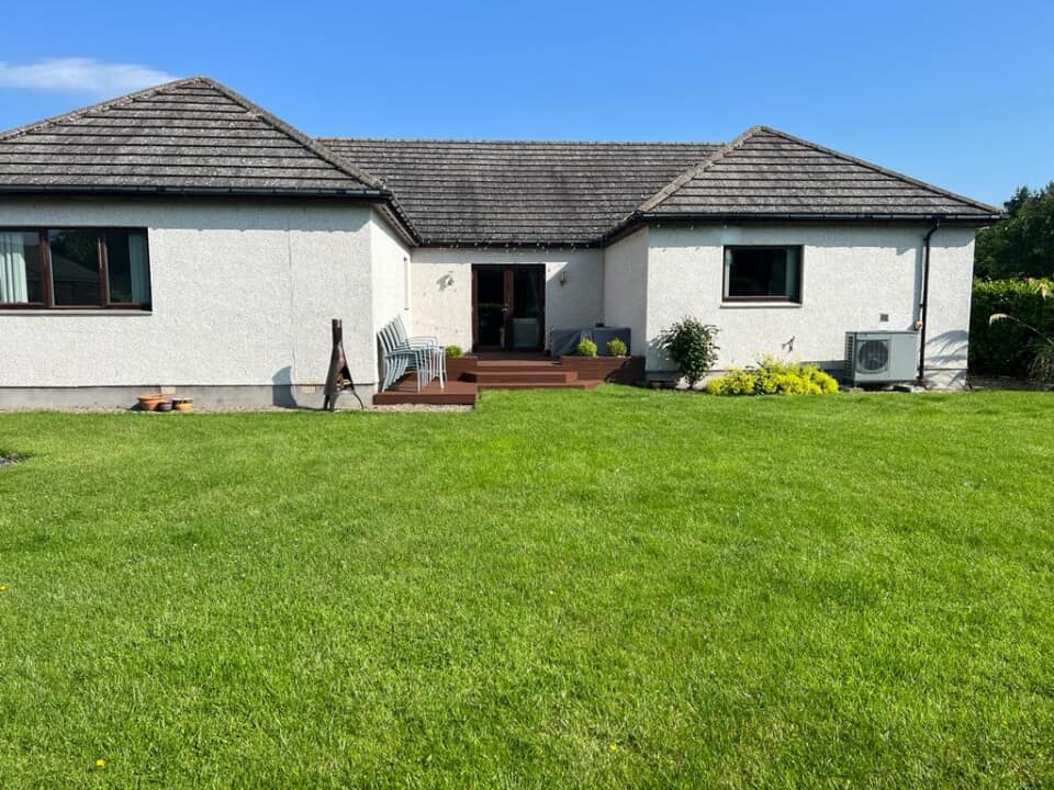 Picture of a self-built bungalow in the sunshine.