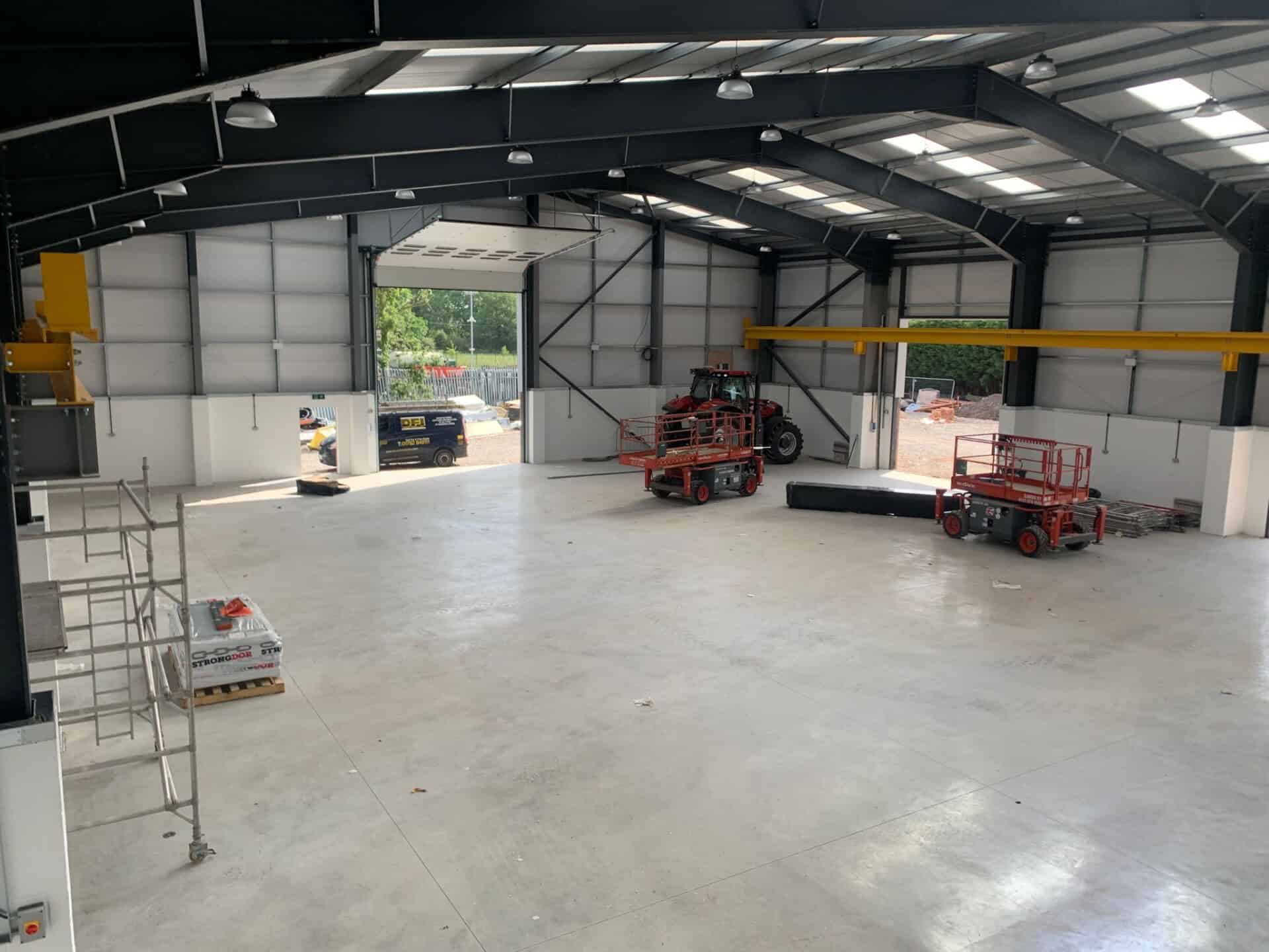 A very large warehouse with concrete floor