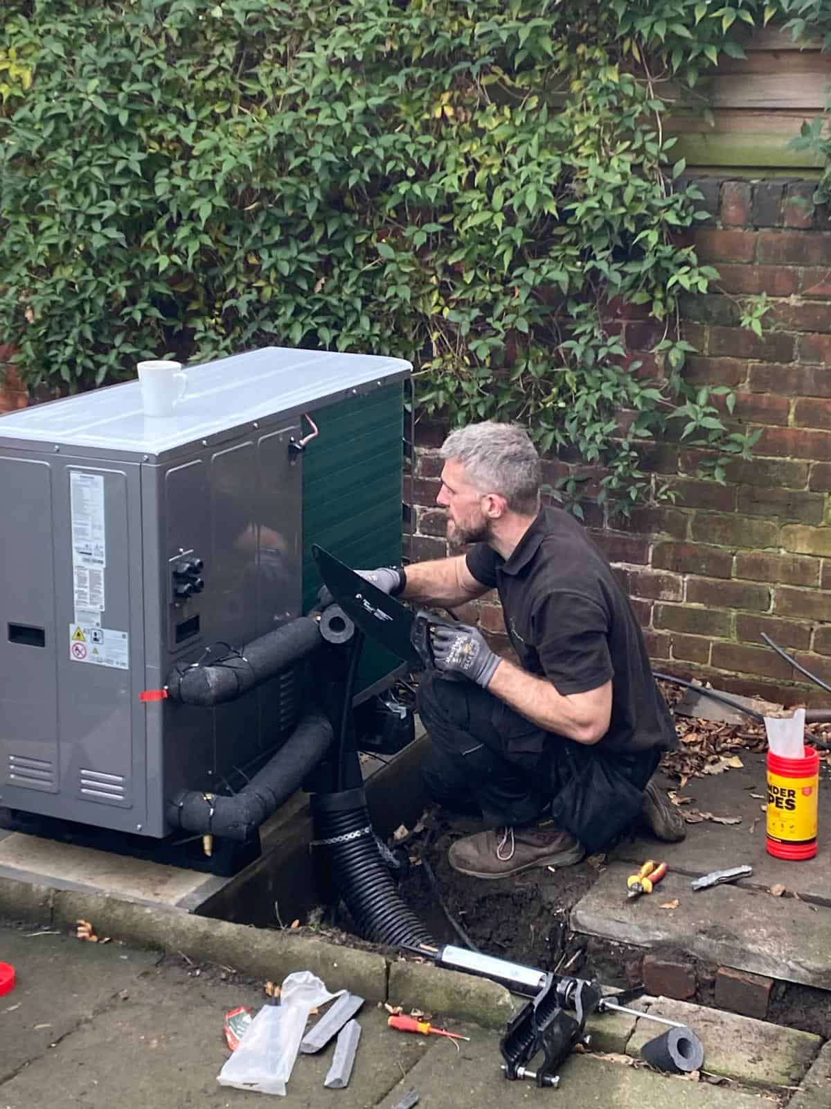 IMS Heat Pumps engineer connecting insulated pipework to a Samsung EHS air source heat pump during installation at a Sheffield home.