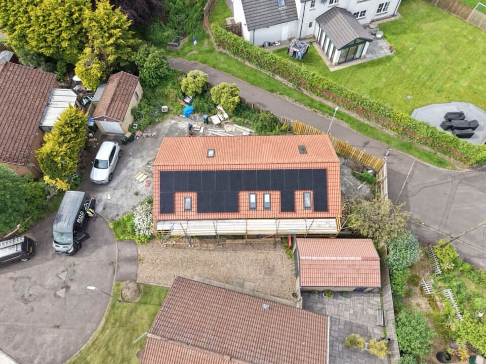 Aerial view of a completed solar panel installation on a detached home in Kinross.