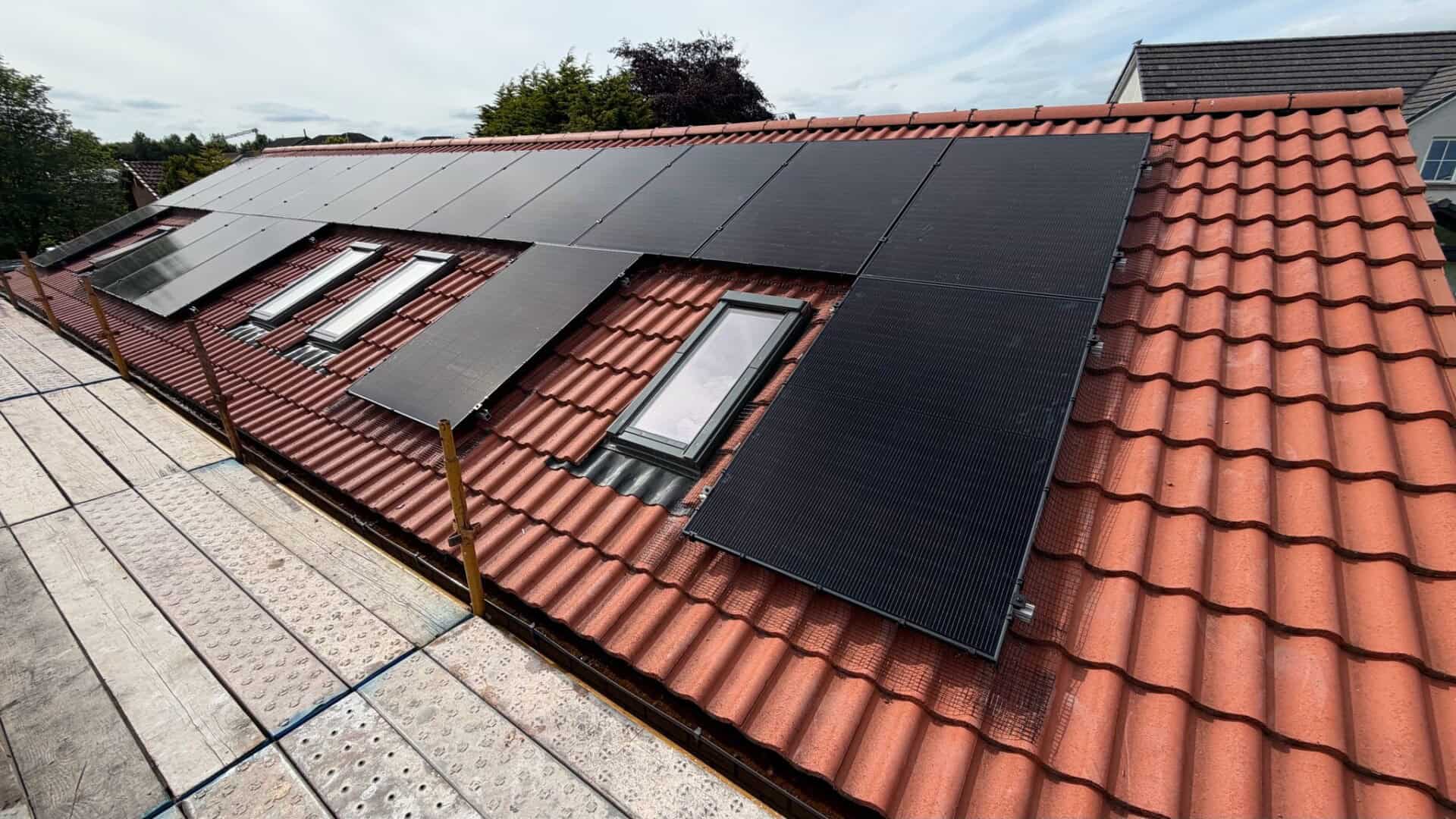 Completed 18-panel solar panel installation on a detached home, designed around multiple rooflights.