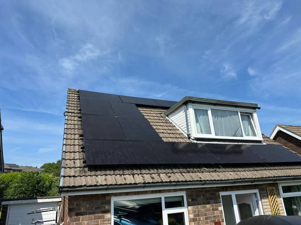 Completed solar PV installation on a detached home with a dormer roof.