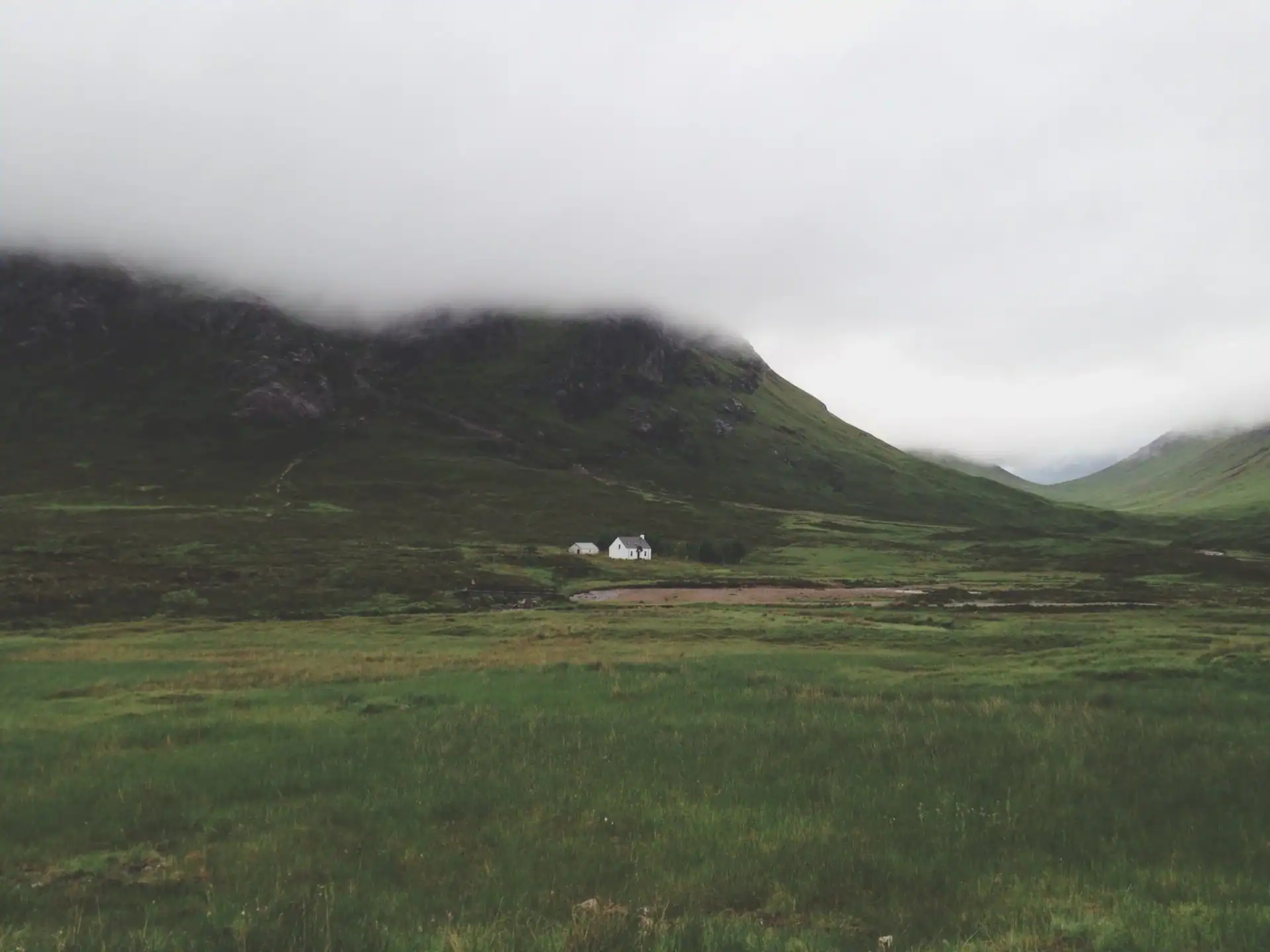 Home in the Scottish highlands with misty mountain in background